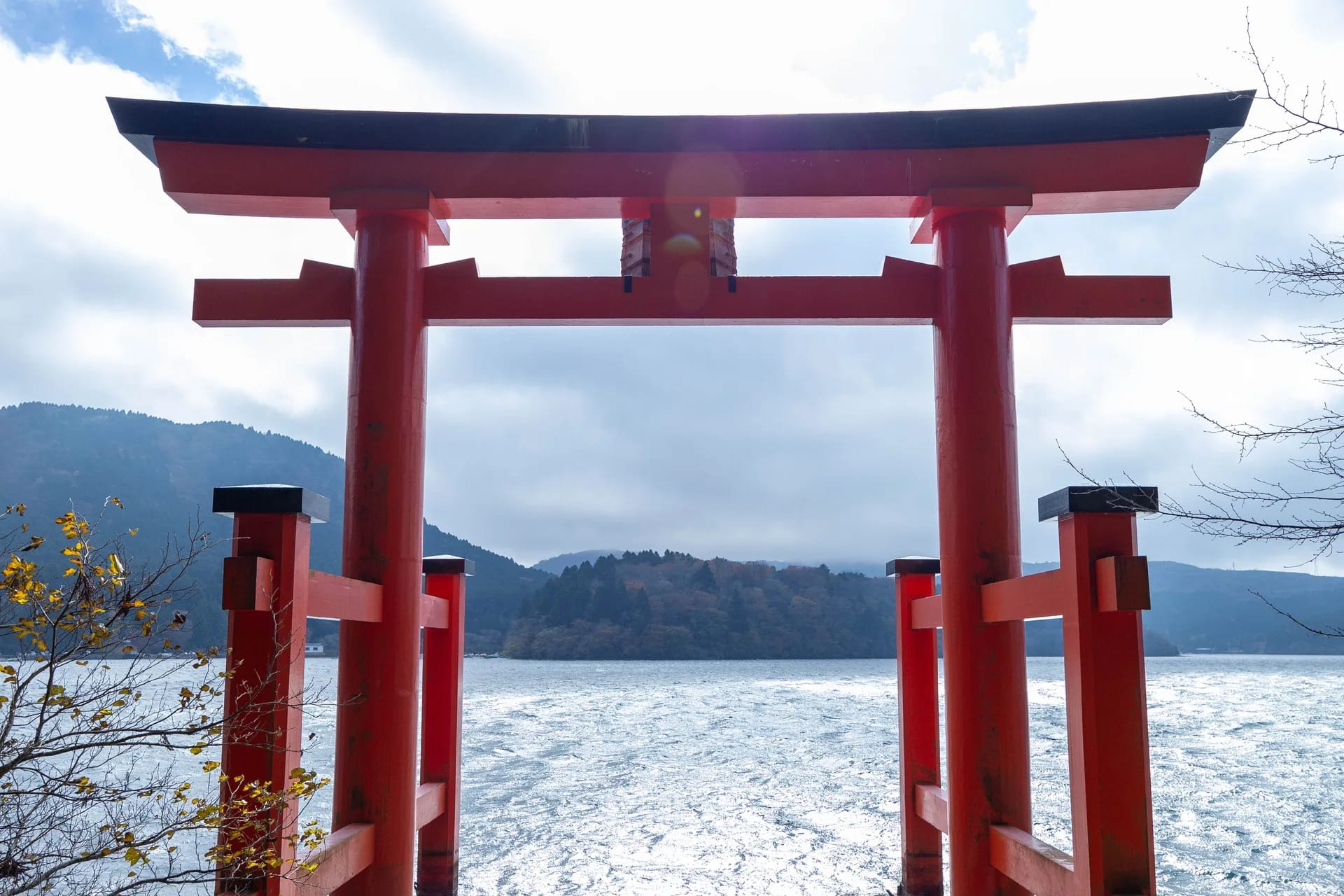 Red torii gate on the shore of Lake Ashi