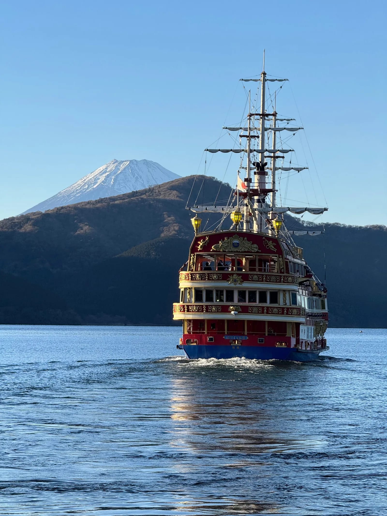 Red and gold pirate ship on the lake with Mount Fuji in the distance