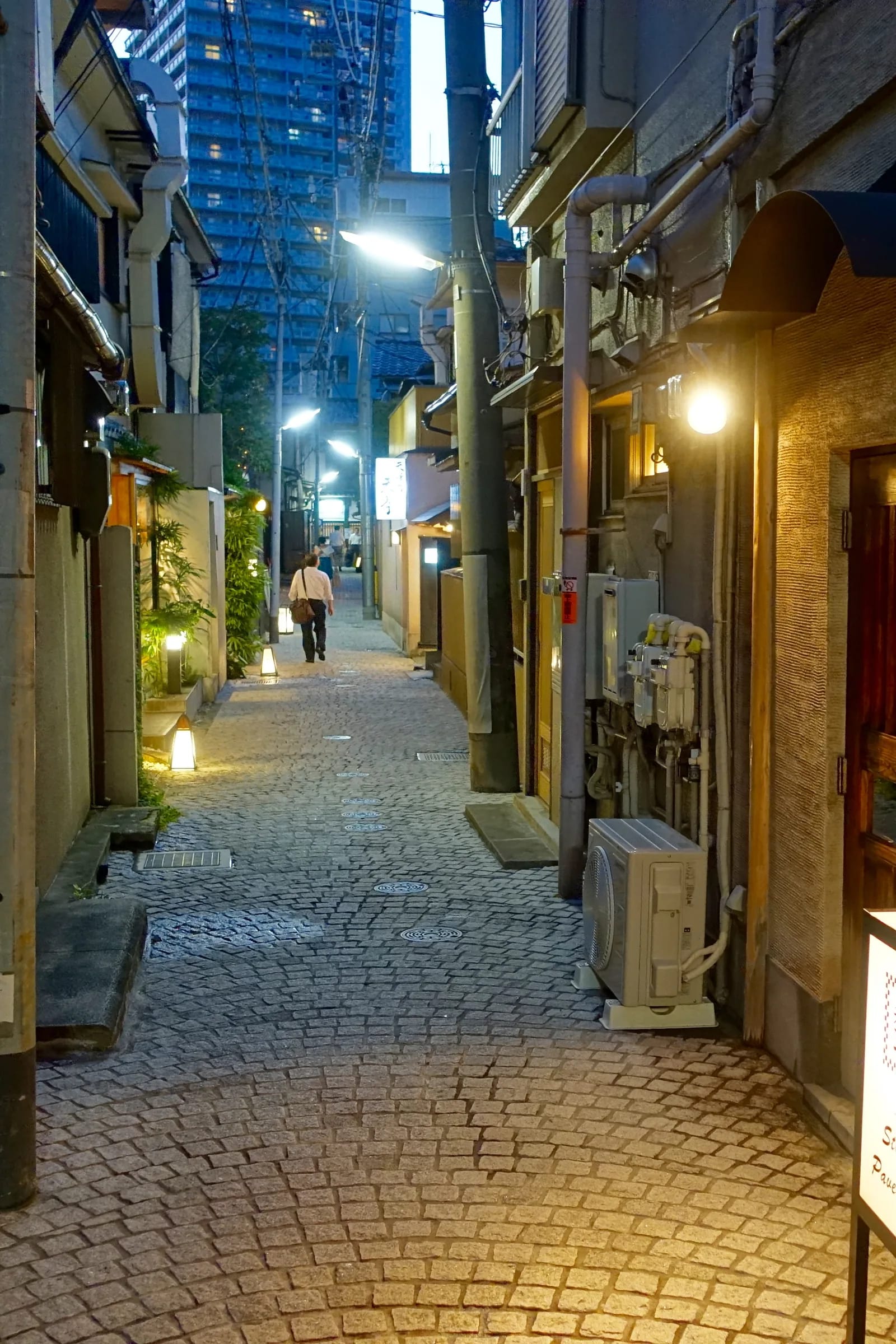 Cobbled alley in Kagurazaka in the evening with lamps and bars