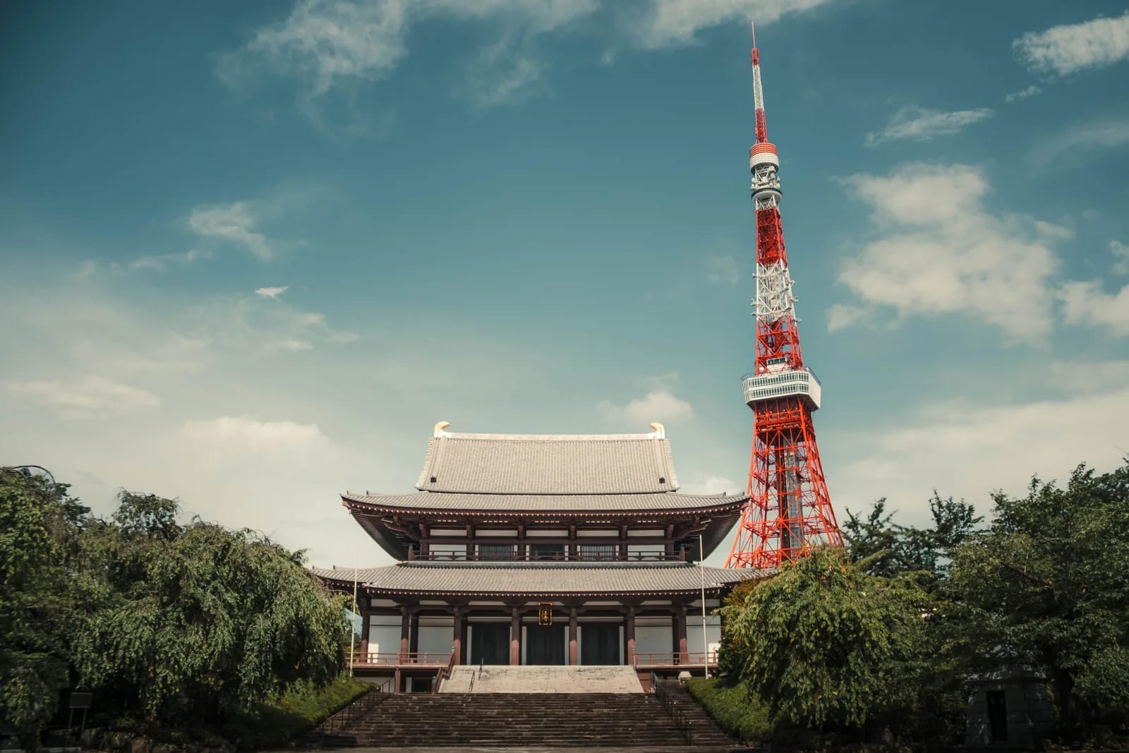 Zojo-ji temple hall with the red Tokyo Tower behind it