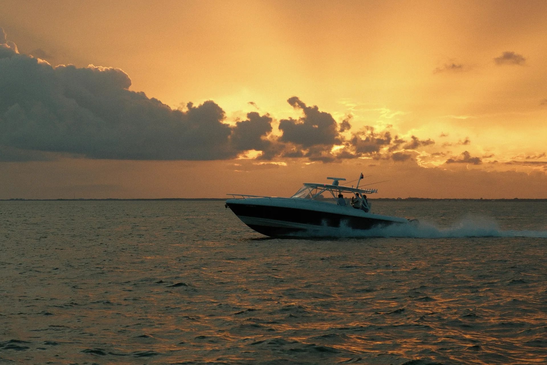 Motorboat crossing the bay off Miami in the golden light of sunset