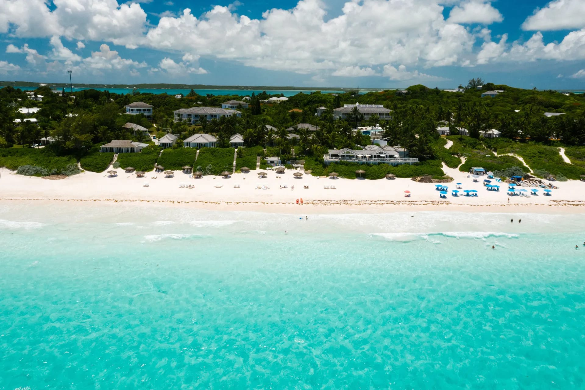 White sand beach with villas and turquoise water in the Bahamas