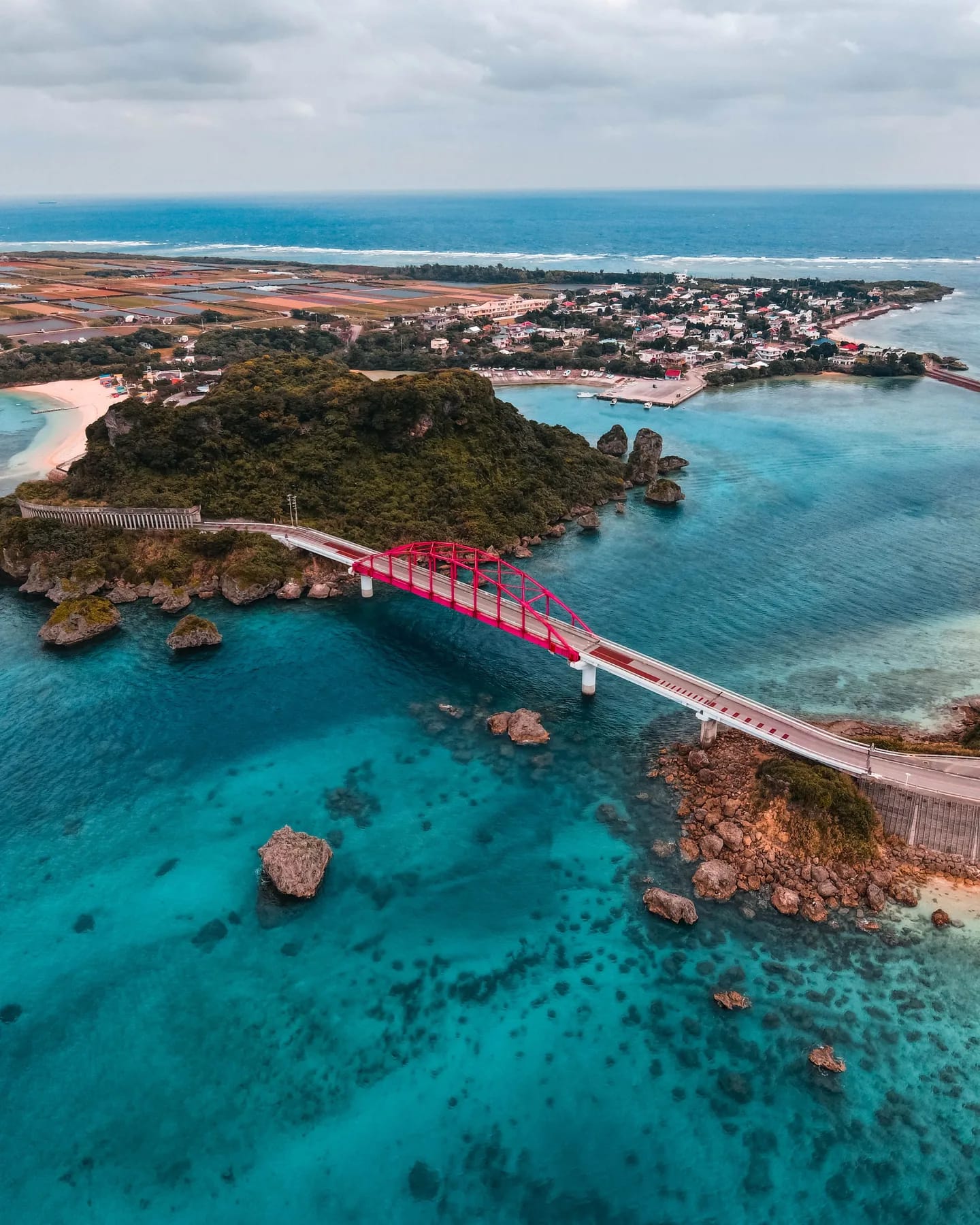Aerial view of a bridge and coral reefs in Okinawa