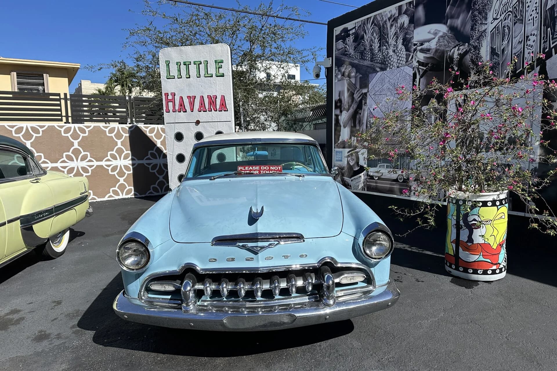 Classic car in front of the Little Havana sign on Calle Ocho