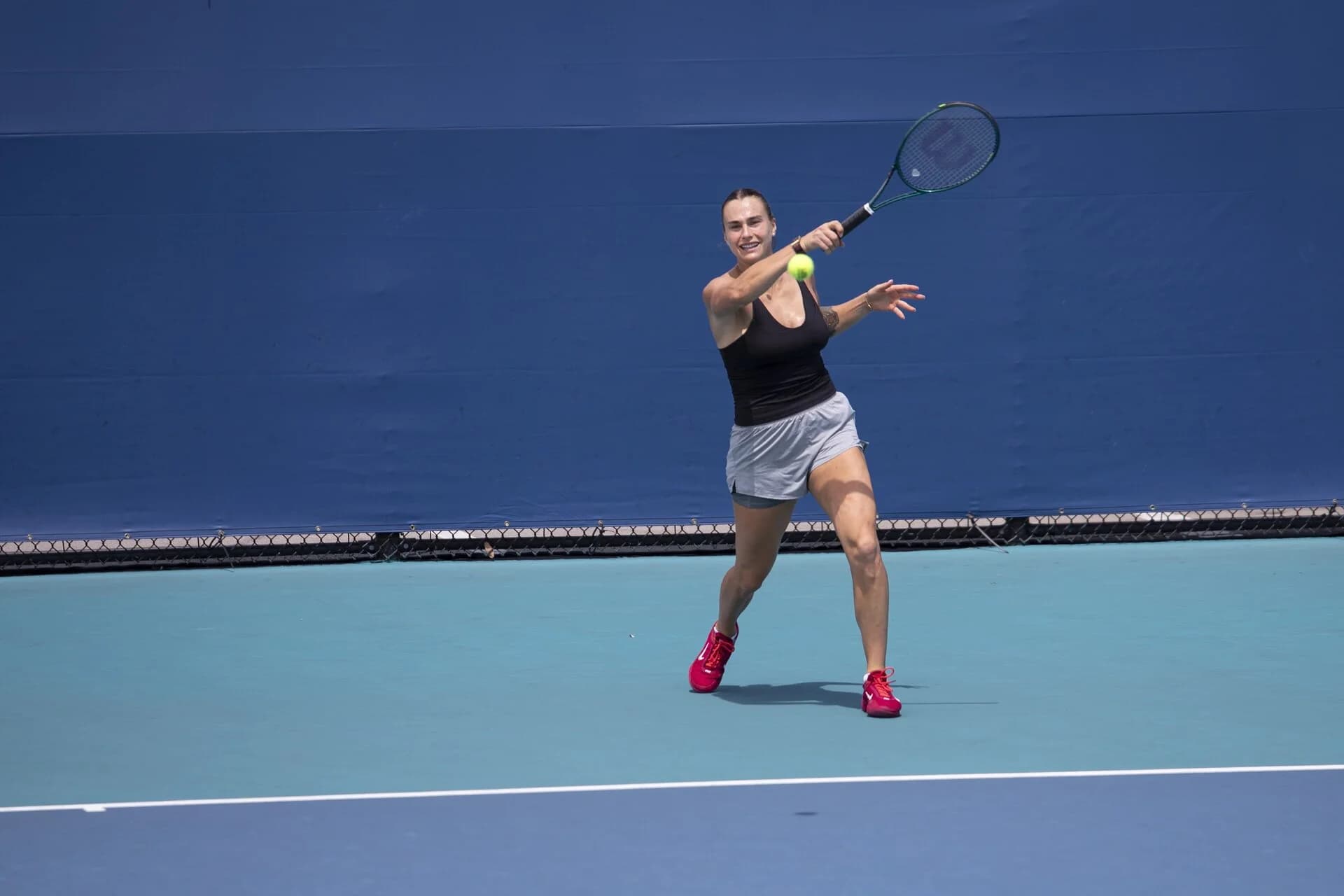 A player hitting a forehand on the blue hard court at the Miami Open