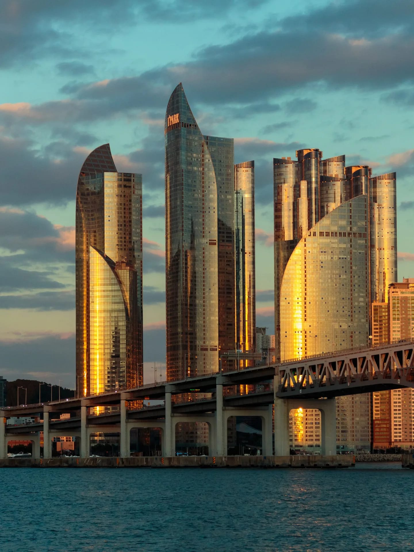 The towers of Busan in evening light above the water
